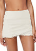 Front view of model wearing white tulip hem tassels mid-waist ruched swim skirt