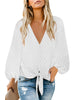 Front view of model wearing white long sleeves swiss dot button down tie-front top