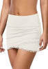 Model poses wearing white tulip hem tassels mid-waist ruched swim skirt