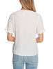 Back view of model wearing white ruffle trim short sleeves V-neck button-down top