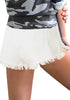 Model wearing white frayed raw hem distressed high-waist denim shorts