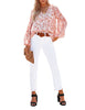 Full front view of model wearing white long sleeves V-neckline floral-print boho blouse