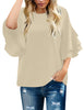 Front view of model wearing beige trumpet sleeves keyhole-back blouse