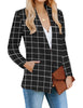 Angled view of model wearing black plaid open-front side pockets blazer