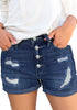 Front view of model wearing deep blue roll-over hem button-up ripped denim shorts