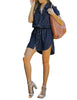 Full front view of model wearing dark blue elastic waist curved hem button down denim shirt dress