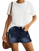 Front view of model wearing blue mid-waist raw hem distressed faded denim shorts