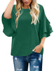 Front view of model wearing dark green trumpet sleeves keyhole-back blouse