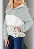 Angled shot of model wearing grey colorblock half-zip hooded fleece pullover