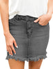 Model poses wearing grey frayed hem washed denim mini skirt