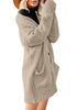 Side view of model wearing beige button down drop shoulders oversized knit cardigan