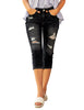 Model wearing black below-knee cropped skinny denim jeans