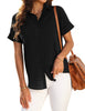 Posing model wearing black short cuffed sleeves pockets button-up top