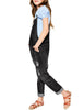 Side view of model wearing black cuffed hem distressed girls' denim jeans overall