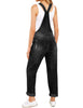 Back view of model wearing black cuffed hem ripped bib denim overall jumpsuit
