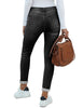 Back view of model wearing back fleece-lined button-down denim skinny jeans