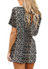 Back view of model wearing leopard-print short sleeves keyhole-back belted romper