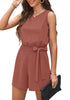 Front view of model wearing dark coral sash belt keyhole-back sleeveless romper