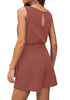 Back view of model wearing dark coral sash belt keyhole-back sleeveless romper