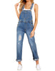 Model poses wearing light blue cuffed hem ripped bib denim overall jumpsuit