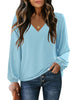 Front view of model wearing light blue V-neckline bishop sleeves loose fit women's top