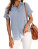 Posing model wearing light blue short cuffed sleeves pockets button-up top