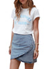 Model wearing light blue acid wash tulip ruched denim mini skirt