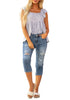 Full front view of model wearing light blue below knee cropped skinny denim jeans