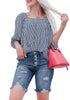 Model wearing blue frayed hem ripped button-up denim bermuda shorts