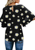 Back view of model wearing black trumpet sleeves keyhole-back daisy printed blouse