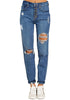 Front view of model wearing women's dark blue distressed button-up boyfriend jeans