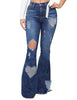 Model poses wearing  dark blue mid-waist ripped heart flared denim