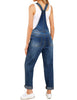 Back view of model wearing dark blue cuffed hem ripped bib denim overall jumpsuit