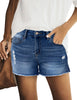 Frontal view of model wearing dark blue mid-waist raw hem distressed faded denim shorts