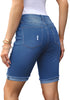 Back view of model wearing blue plus size mid-waist ripped denim bermuda shorts.