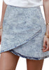 Angled view of model wearing grey acid wash tulip ruched denim mini skirt