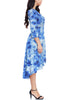 Side view of model wearing blue tie-dye high-low plus size wrap skater dress