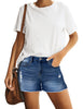 Front view of model wearing dark blue mid-waist raw hem distressed faded denim shorts