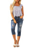 Full front view of model wearing blue below knee cropped skinny denim jeans