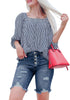 Front view of model wearing deep blue frayed hem ripped button-up denim bermuda shorts