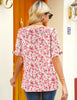 Back view of model wearing pink ruffle trim short sleeves printed v-neck button-down top