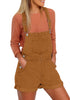 Front view of model wearing camel  rolled hem shorts denim bib overall