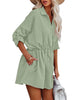 Angled shot of model wearing mint cuffed long sleeves elastic-waist shirt dress