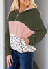 Angled shot of model wearing army green colorblock half-zip hooded fleece pullover