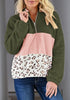 Model poses wearing army green colorblock half-zip hooded fleece pullover