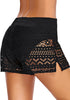 Angled back shot of model in black hollow out side-slit drawstring swim shorts