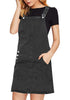 Angled shot of model wearing black side pockets overall denim pinafore dress