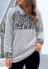 Angled shot of model wearing grey oblique stand collar leopard fleece pullover