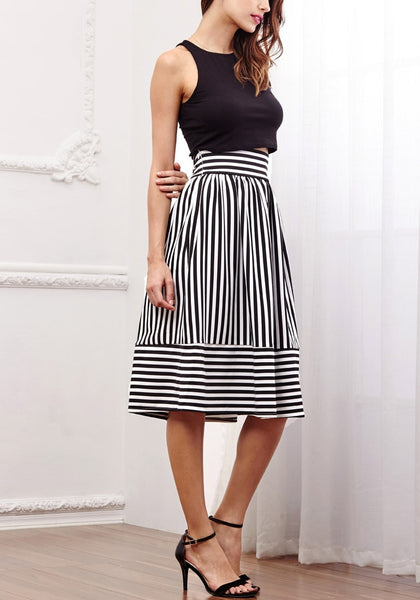 Angled view of model in striped midi skirt