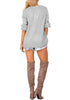 Back full body shot of woman wearing light grey lantern sleeves surplice sweater